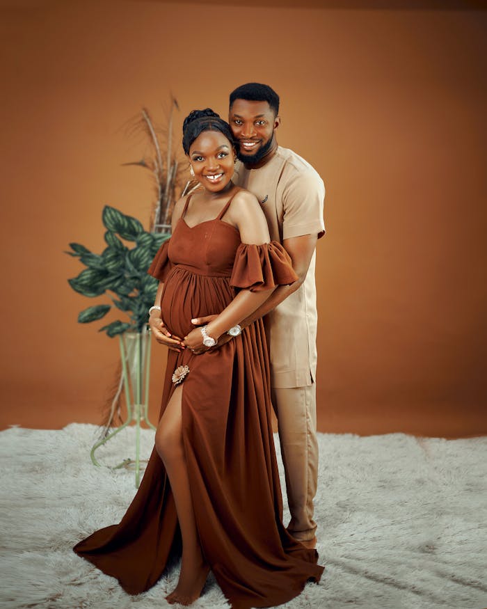 beautiful-maternity-couple-portrait-on-brown-background-33945403